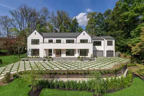 Front of the house with paver motor court and landscaped terrace