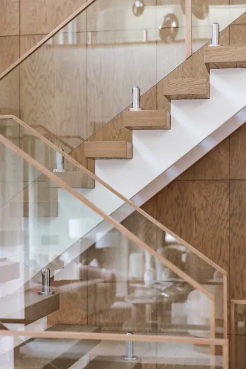 Staircase with glass railing and oak treads