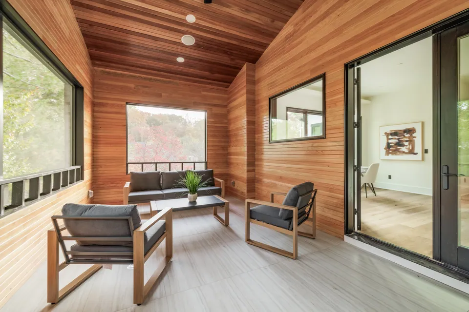 Screened-in porch with wood-paneled walls