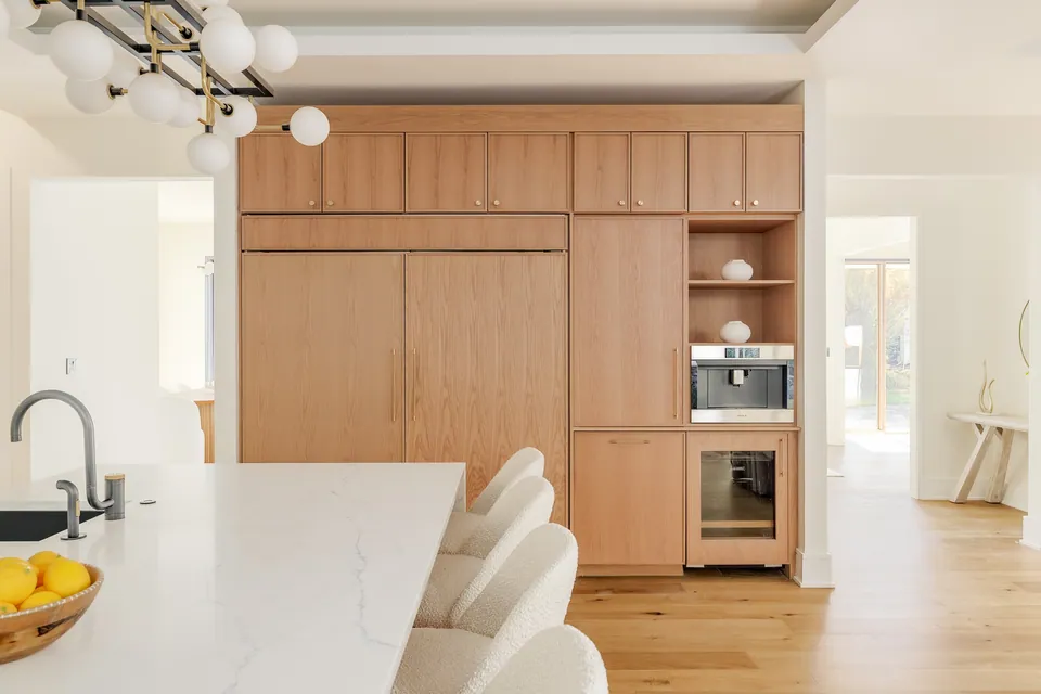 Kitchen with wood-paneled appliance wall